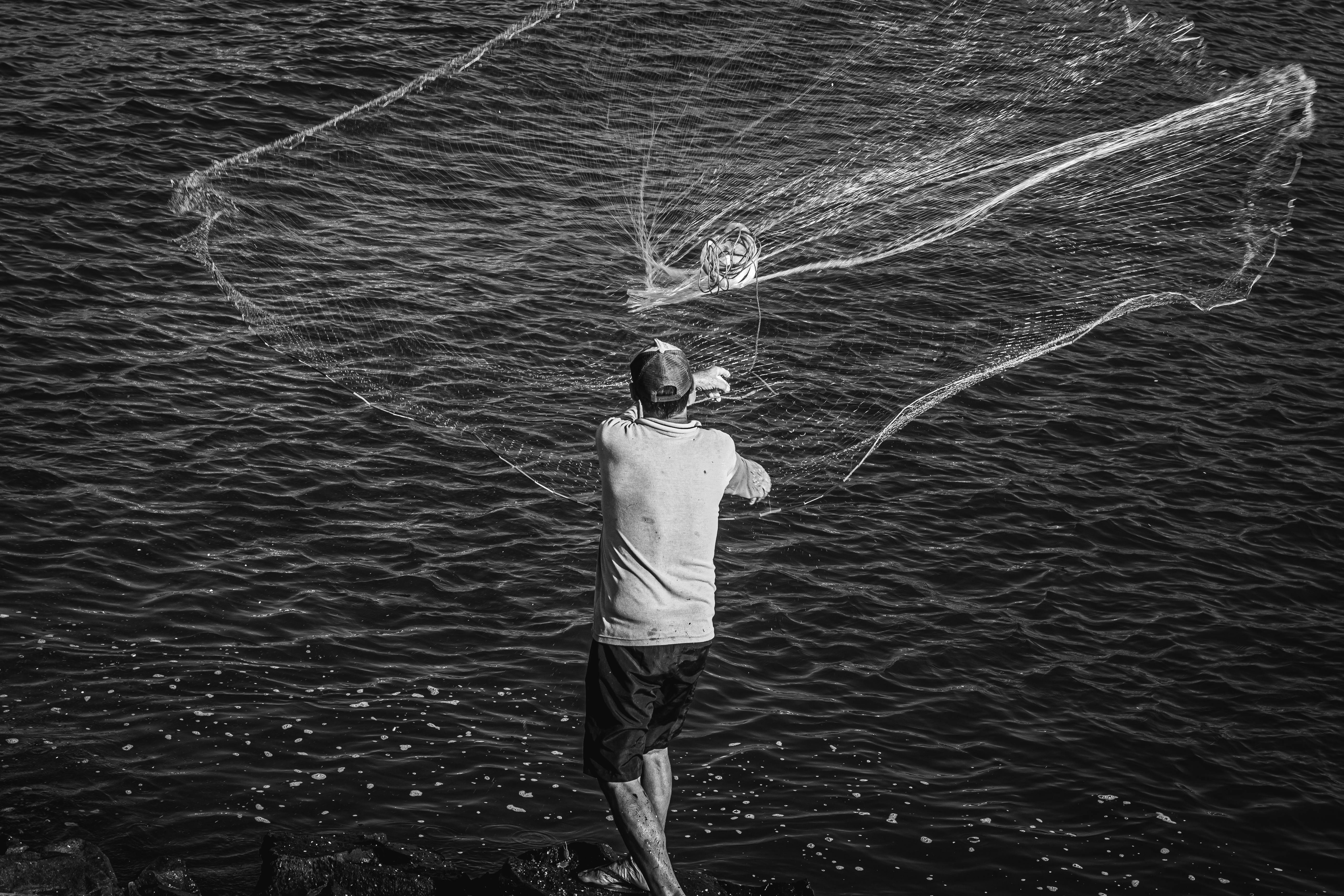 Man Throws Fishing Net Image & Photo (Free Trial)