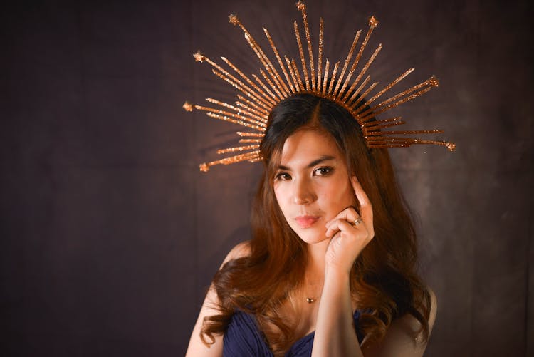 A Beautiful Woman Wearing A Gold Headdress