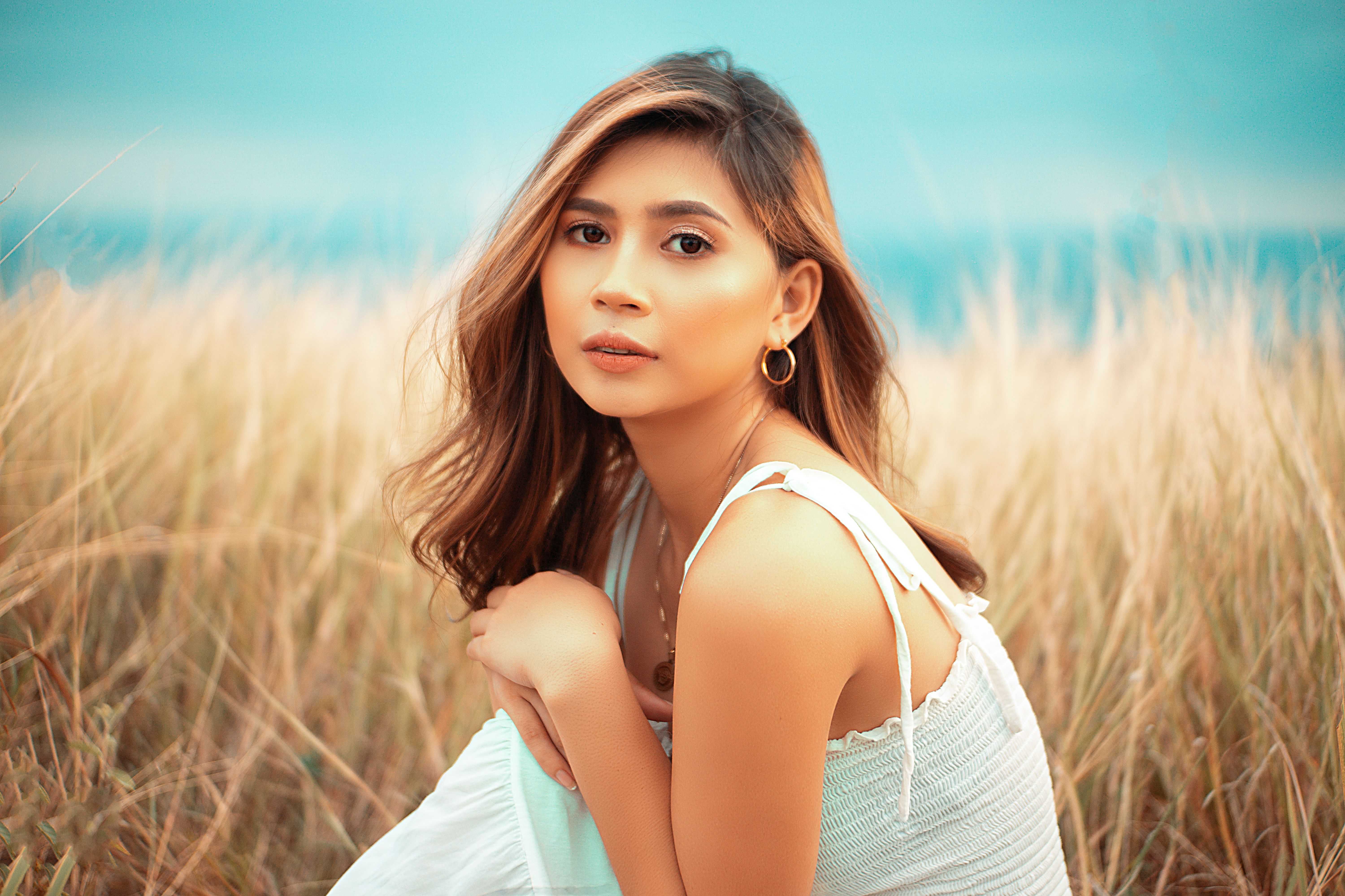 Beautiful Woman Sitting on Meadow · Free Stock Photo