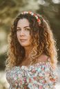  Woman with Long Wavy Hair and Flower Crown in Summer Floral Dress