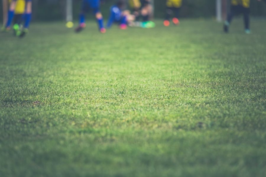 Low-angle view across a floodlit training pitch — Markus Spiske on Pexels