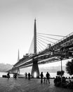 Grayscale Photo of People Walking on Bridge