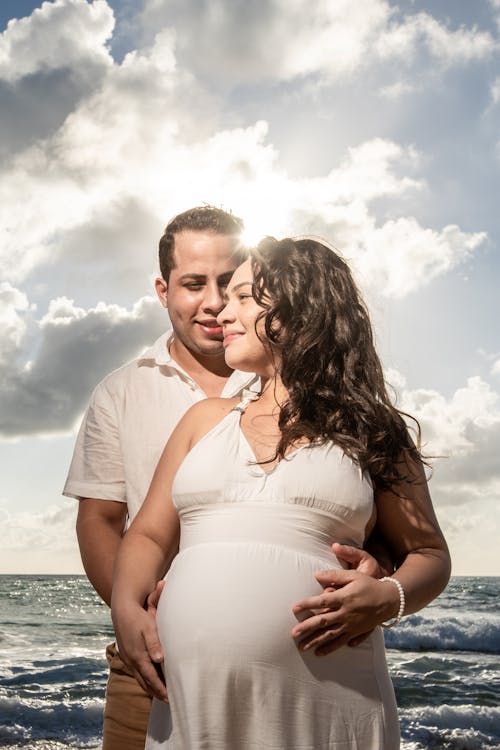 Free Man Standing Behind a Pregnant Woman Stock Photo