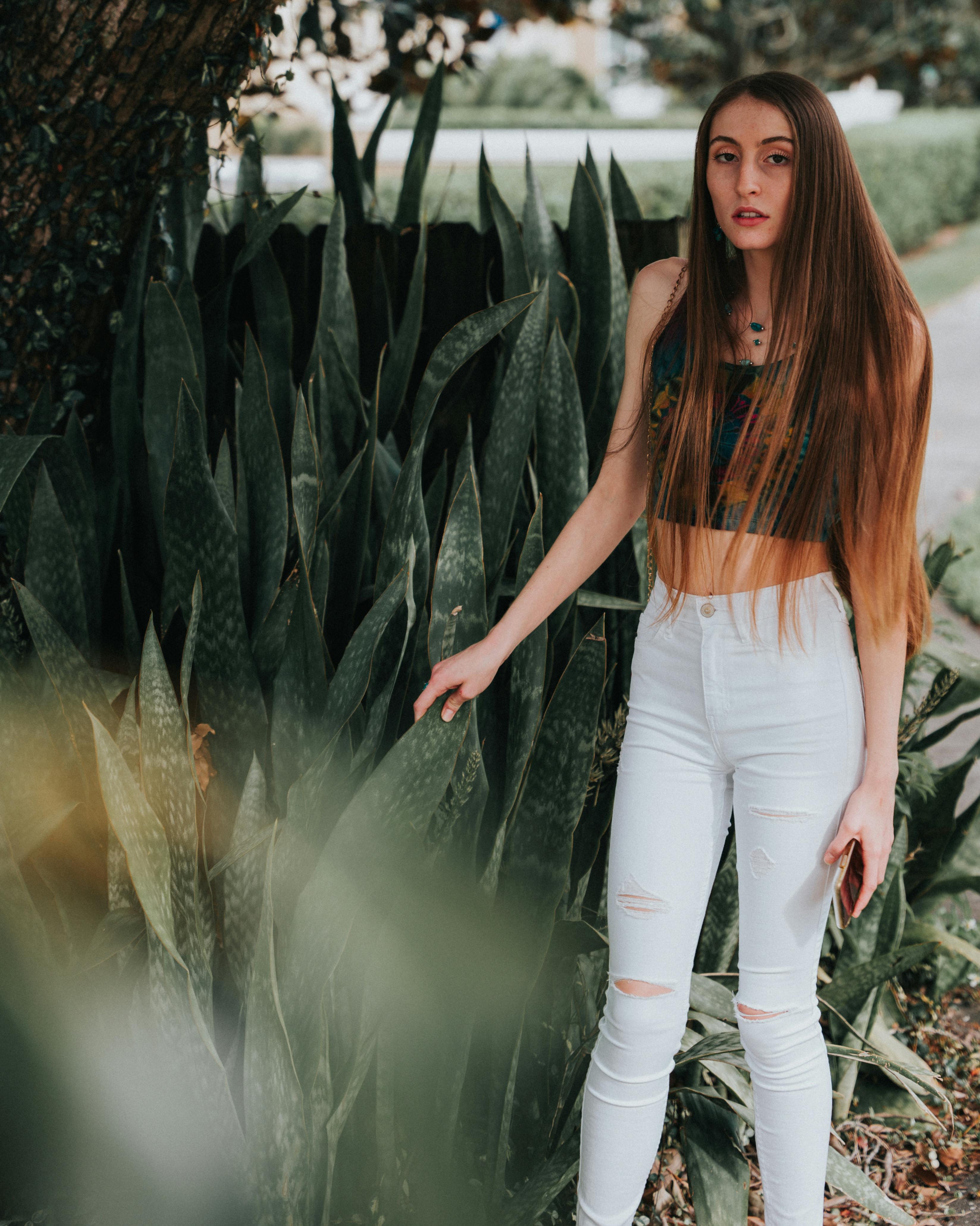 Young Brunette Woman in Black Mesh Crop Top Posing by a Wall · Free Stock  Photo