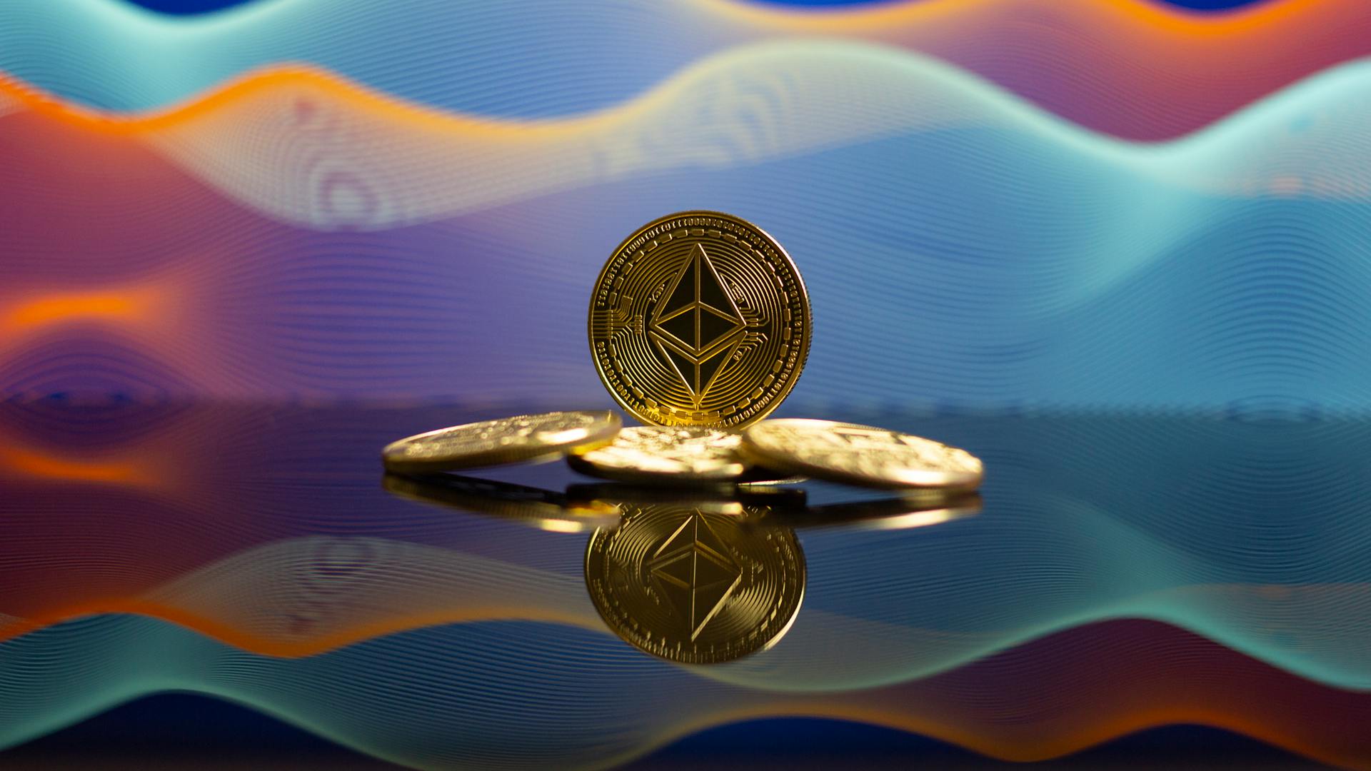 Ethereum coins with a reflective surface and vibrant gradient background, representing cryptocurrency and blockchain technology.