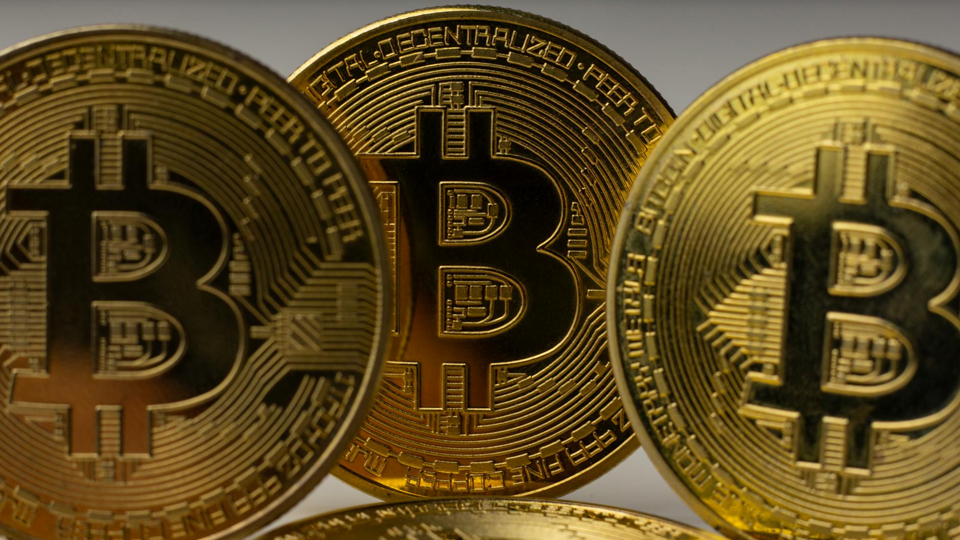 Detailed view of golden bitcoin coins, symbolizing digital currency and blockchain technology.