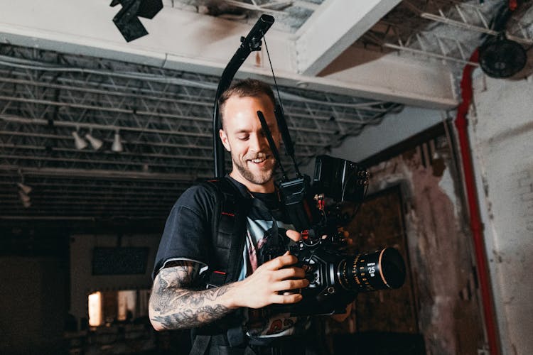 A Photographer Holding A Video Camera