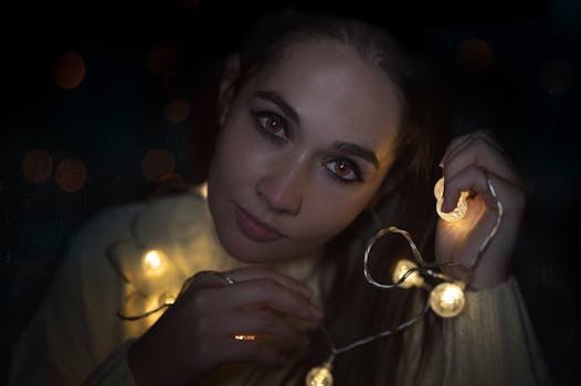 Close-up of a woman with string lights, creating a warm, intimate ambiance.