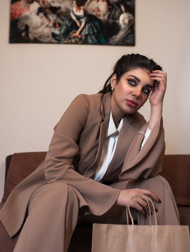 Woman In Suit Sitting