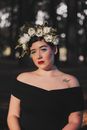 Young Brunette Woman in Black Sleeveless Dress and with Flower Crown on Head 