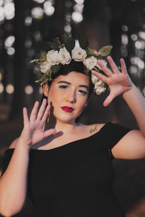 Free Woman in Creative Makeup and Flower Crown on Head Making Gestures Stock Photo