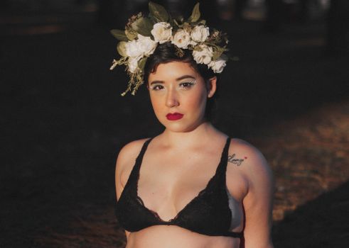 A Woman in Black Brassiere and Floral Headdress