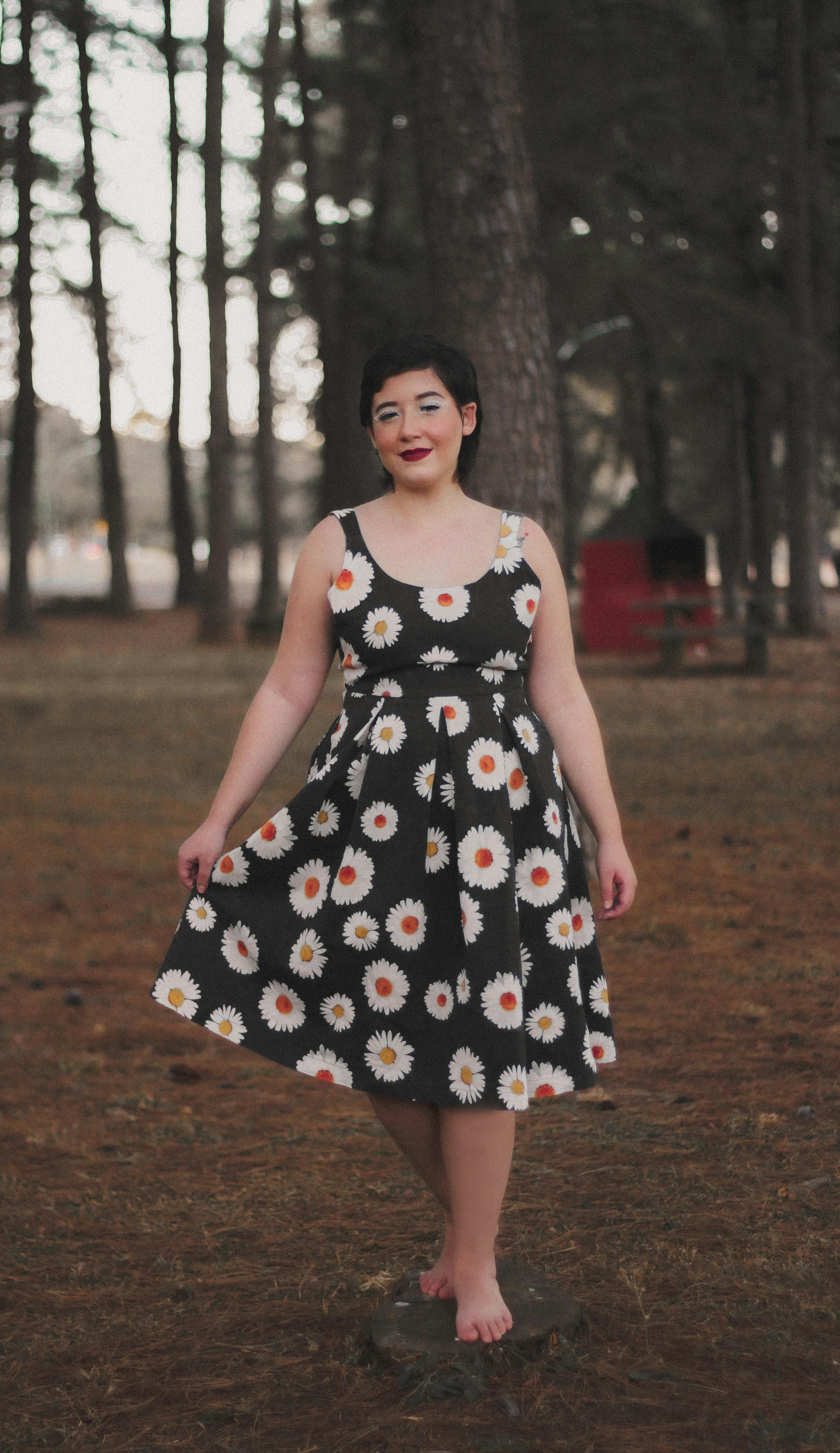 brunette woman in dress barefoot