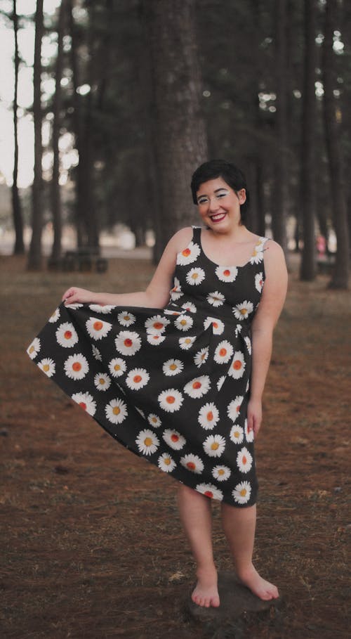 Smiling Woman Wearing a Black Floral Dress