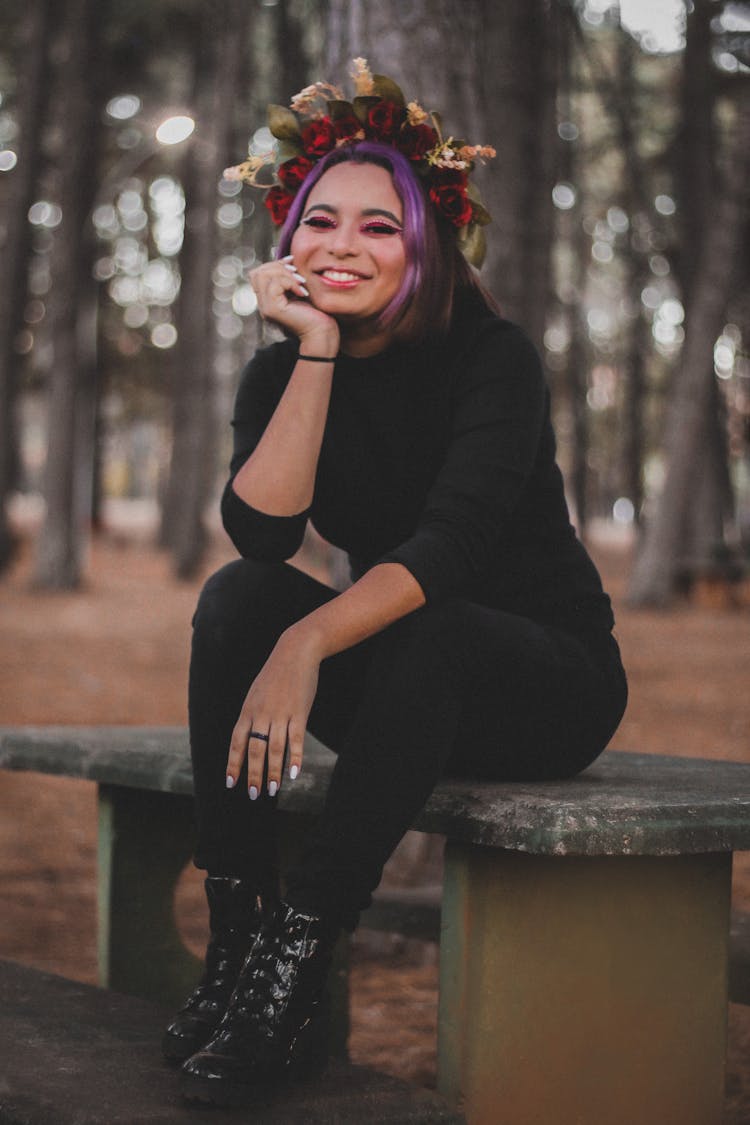 Woman In Black Long Sleeve Shirt And Black Pants Sitting On Table 