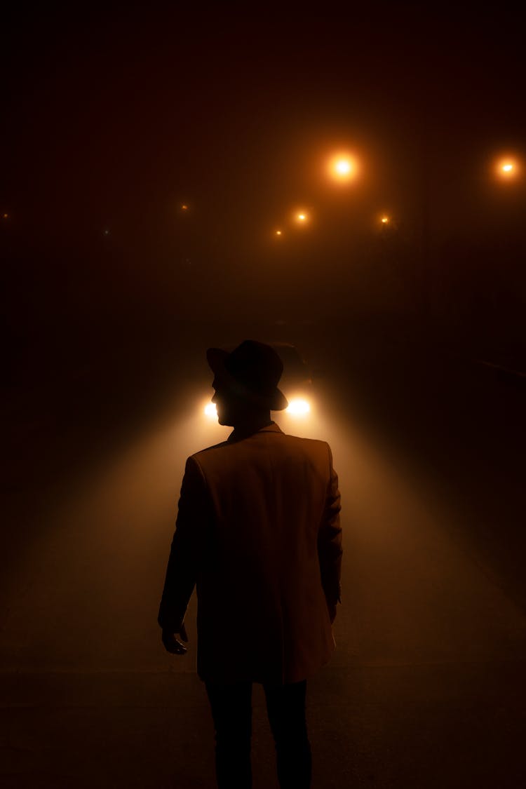 Man Standing At Night In Front Of Light Streak