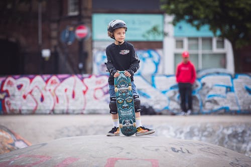 Boy Wearing Helmet Holding Skateboard 
