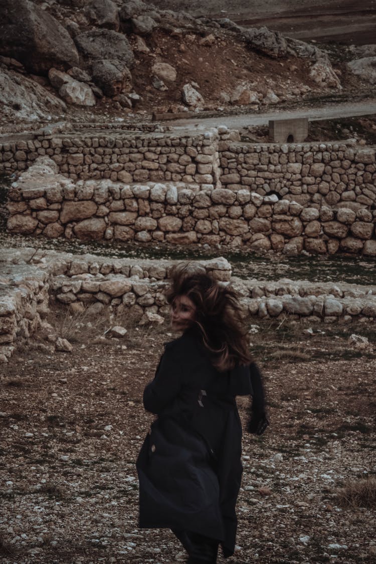 Woman With Long Flying Hair Running And Looking Back