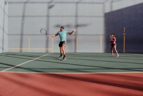 Free Two players engaging in a lively squash game indoors, showcasing skill and athleticism. Stock Photo