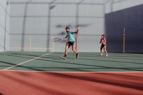 Man and Woman Playing Tennis