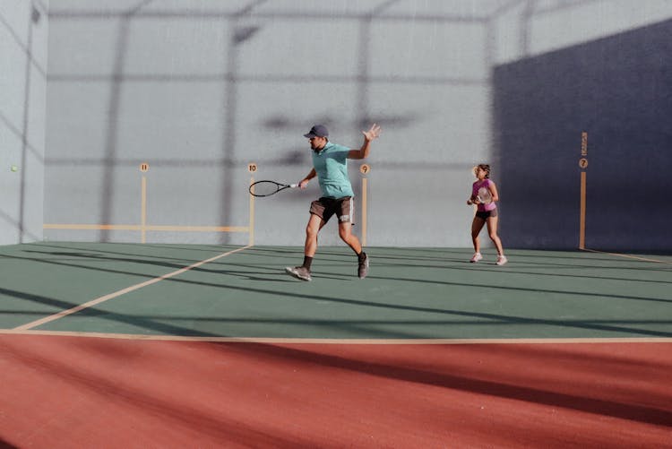 Man And Woman Playing Tennis