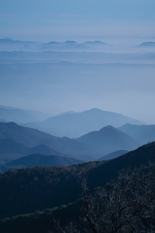 Foggy Mountains Under a Blue Sky