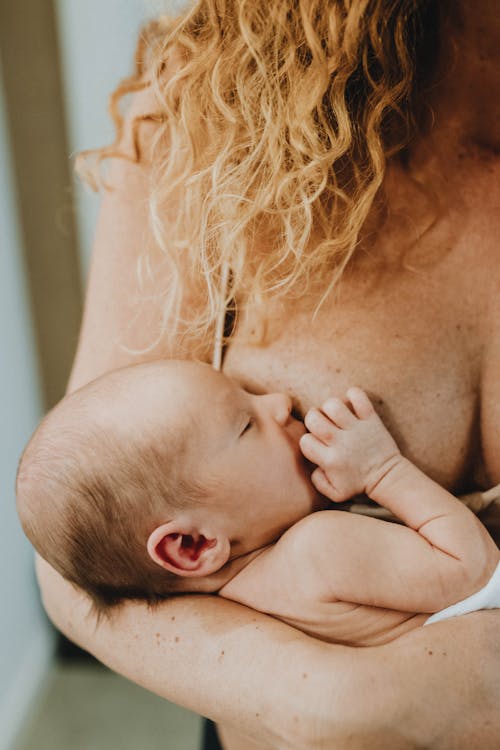 Free Woman Breastfeeding Child Stock Photo