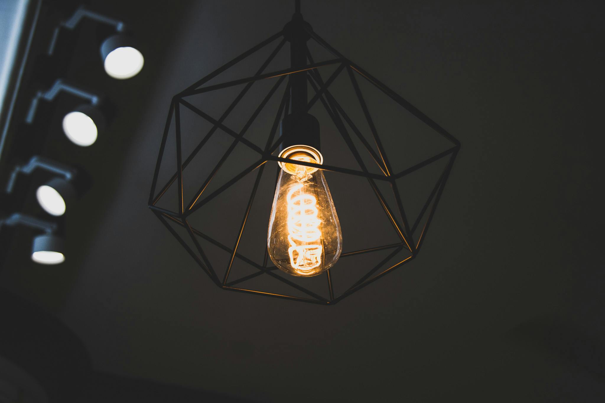 turned on black framed incandescent bulb pendant lamp