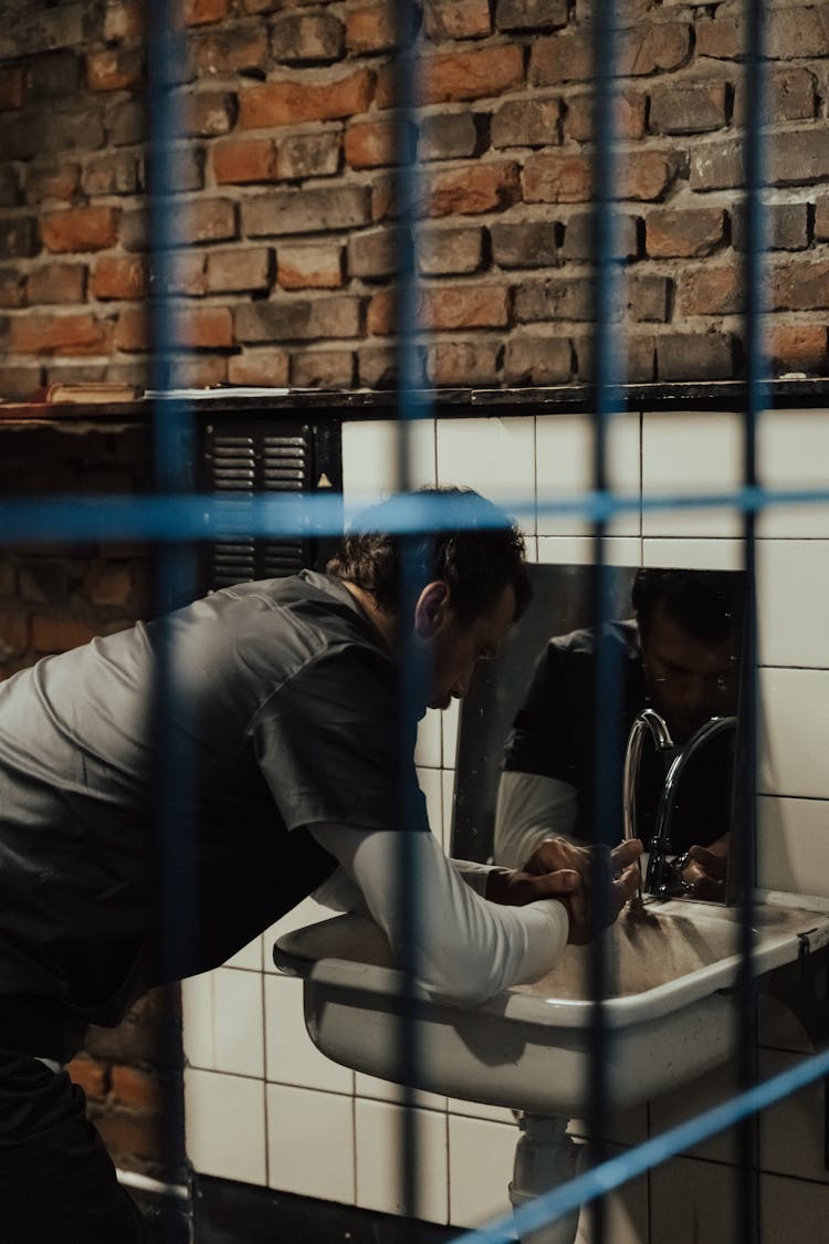 Man Washing Hands In Jail