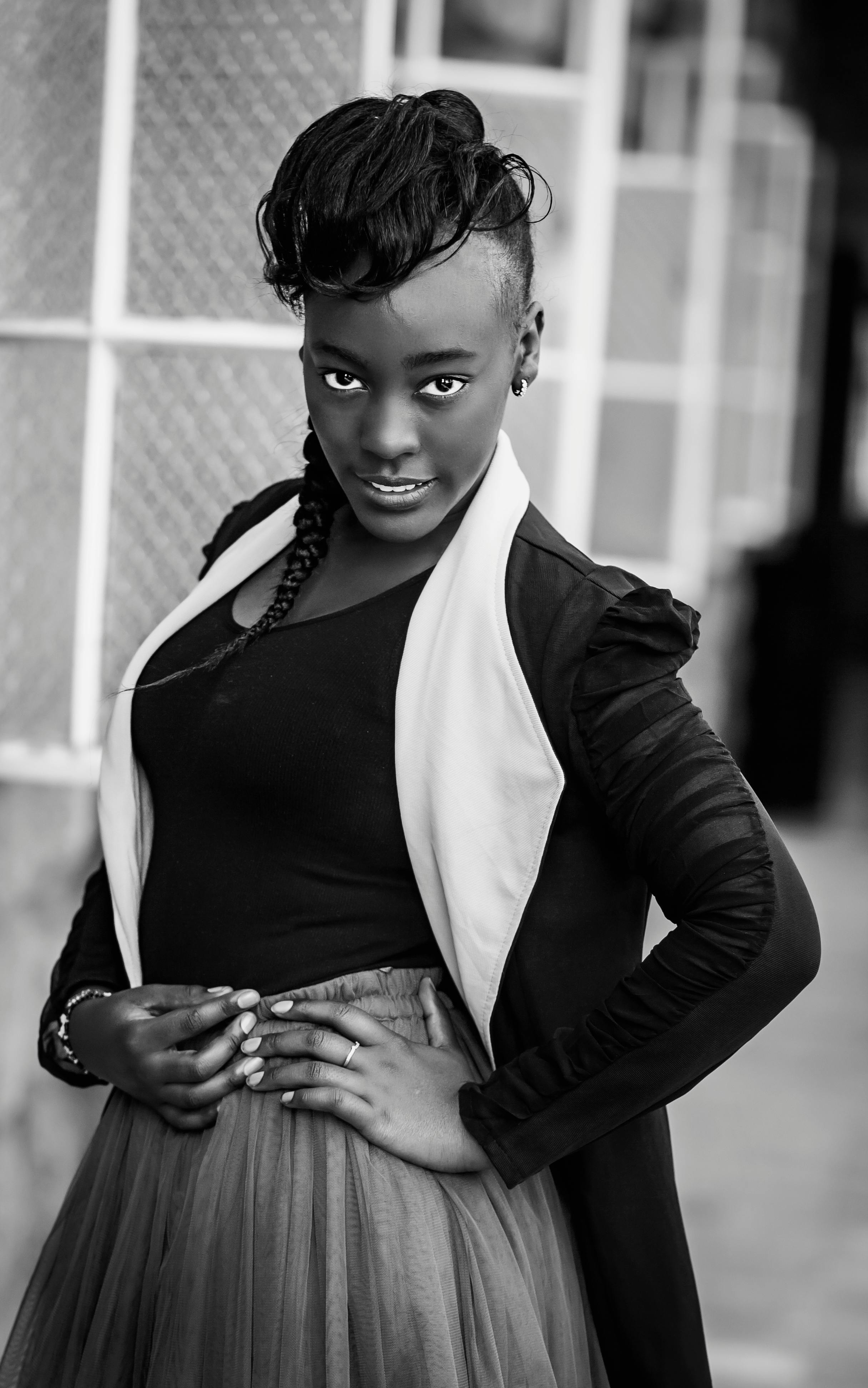 Elegant black and white portrait of a stylish woman posing confidently.