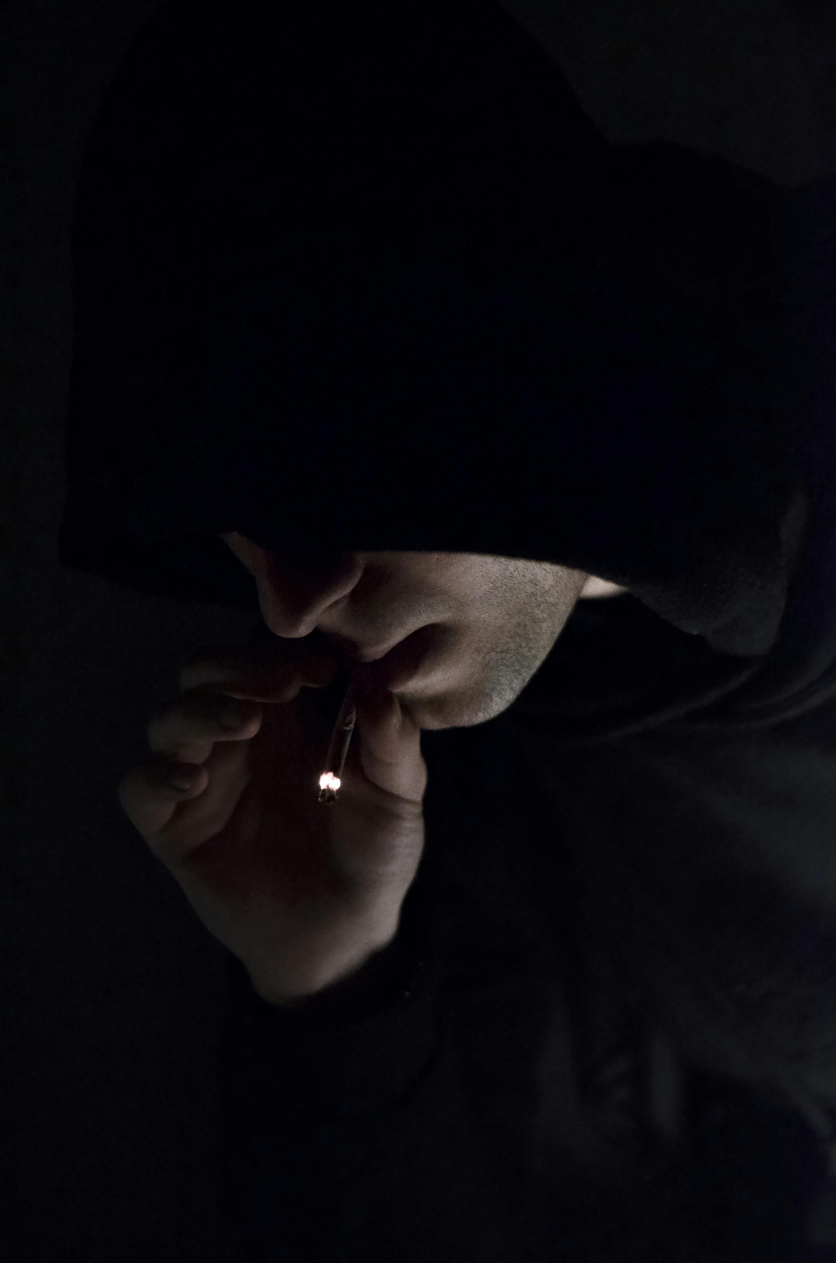 Man in Hoodie Smoking Cigarette · Free Stock Photo