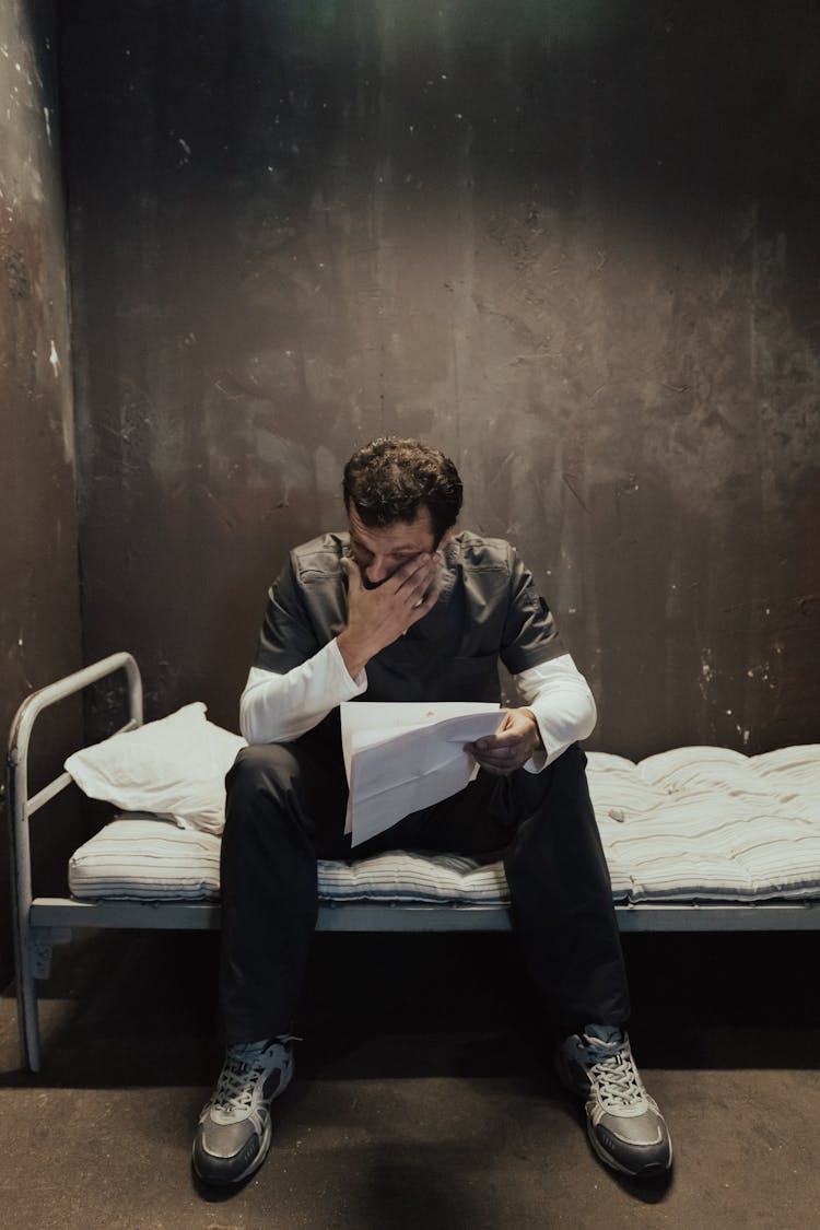 A Man Crying While Reading A Letter