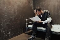 Man in Black Suit Reading Book