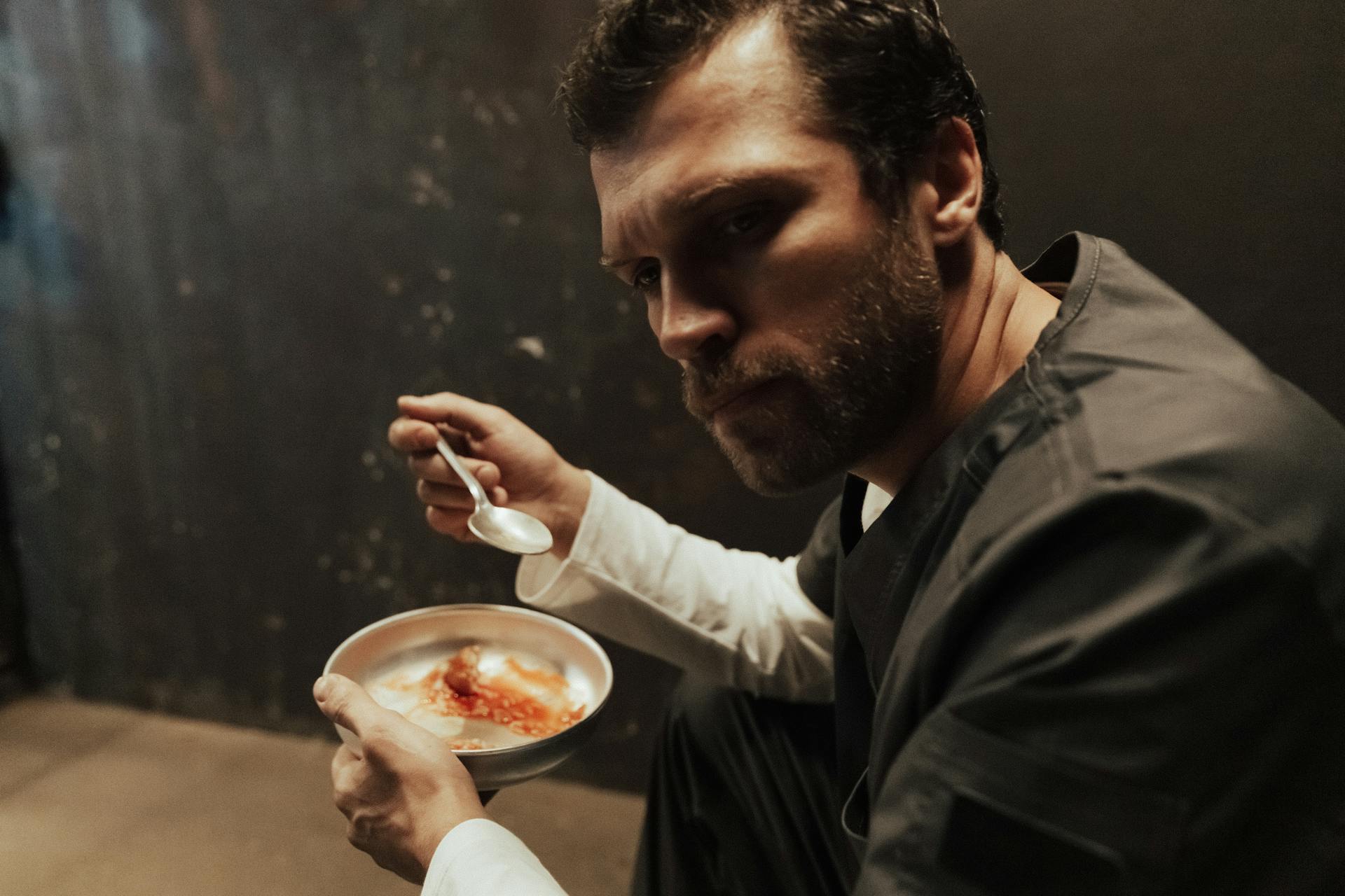 Convict Eating in Prison Cell