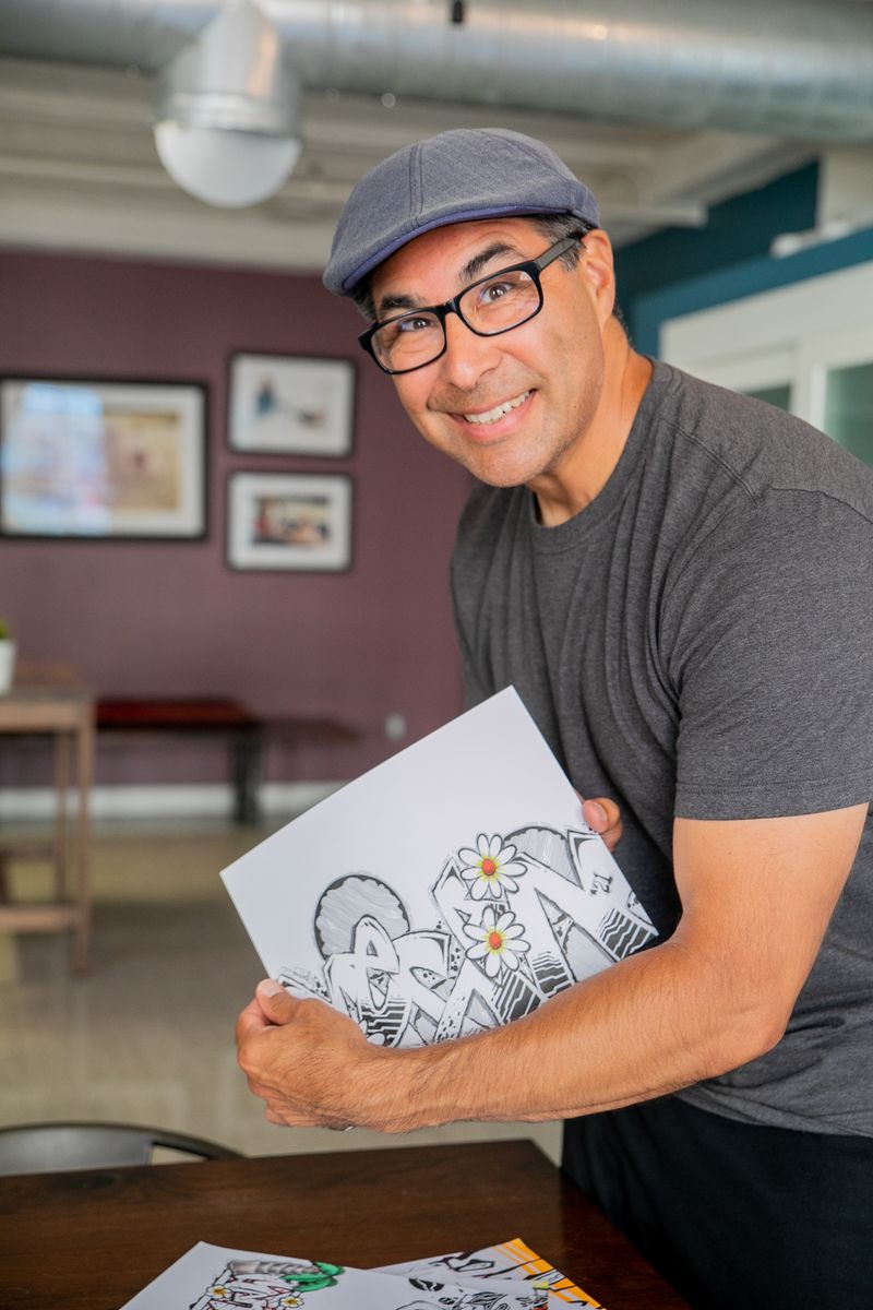 Artist proudly displaying completed artwork