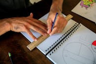 Man Drawing in Sketchbook