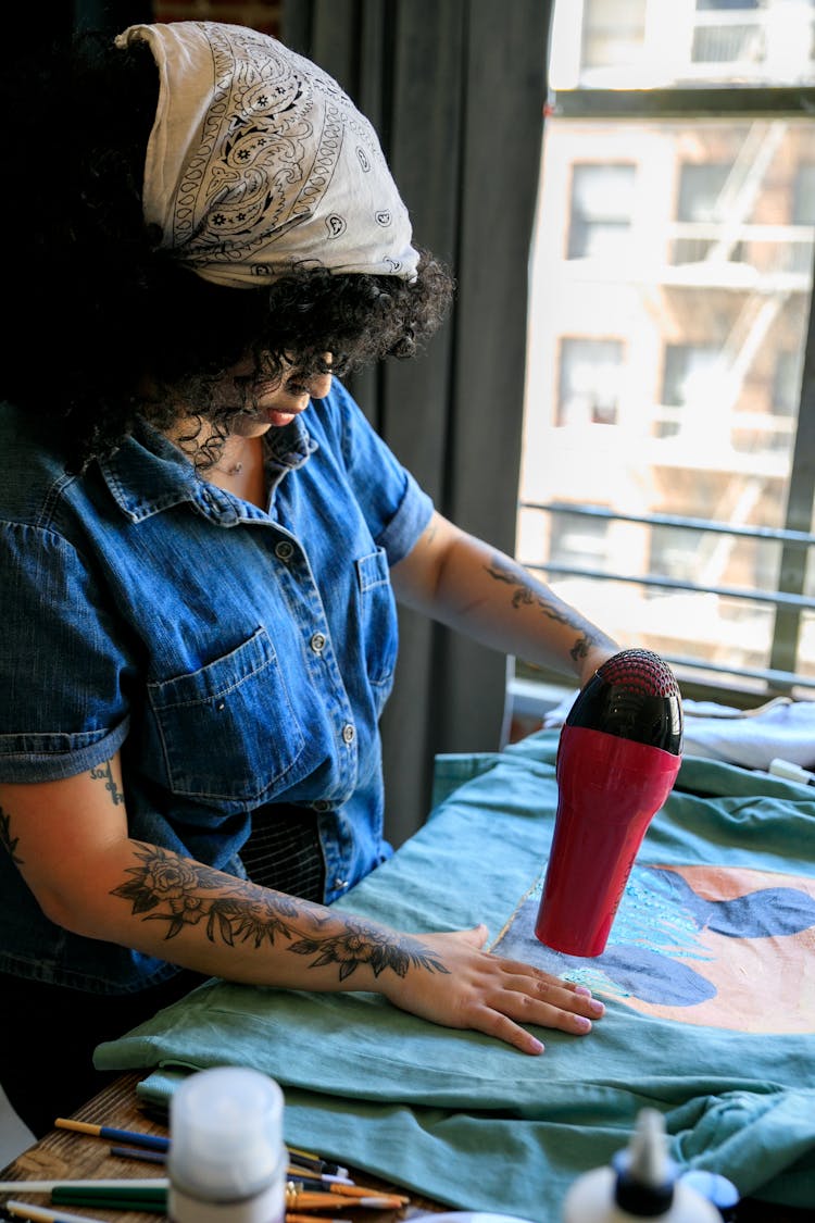 Curly Haired Artist Drying Painting On Cloth