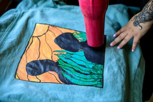 Woman Drying Painting on Cloth