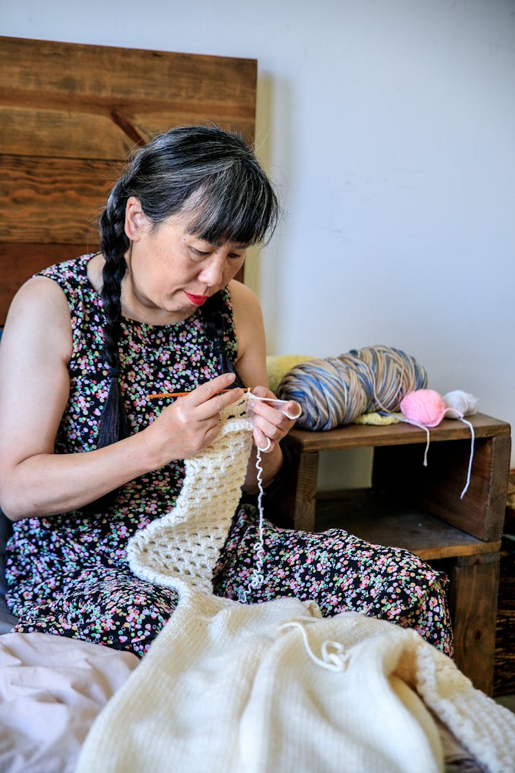 Woman In Dress Crocheting