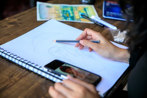 Free Artist Sketching on Paper Stock Photo