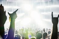 现场音乐会上，充满活力的人群举起双手，庆祝音乐与活力