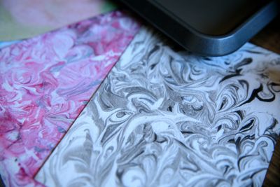 Sheet of marbled paper with swirled pink and grey veining. Photo by RDNE Stock project on Pexels