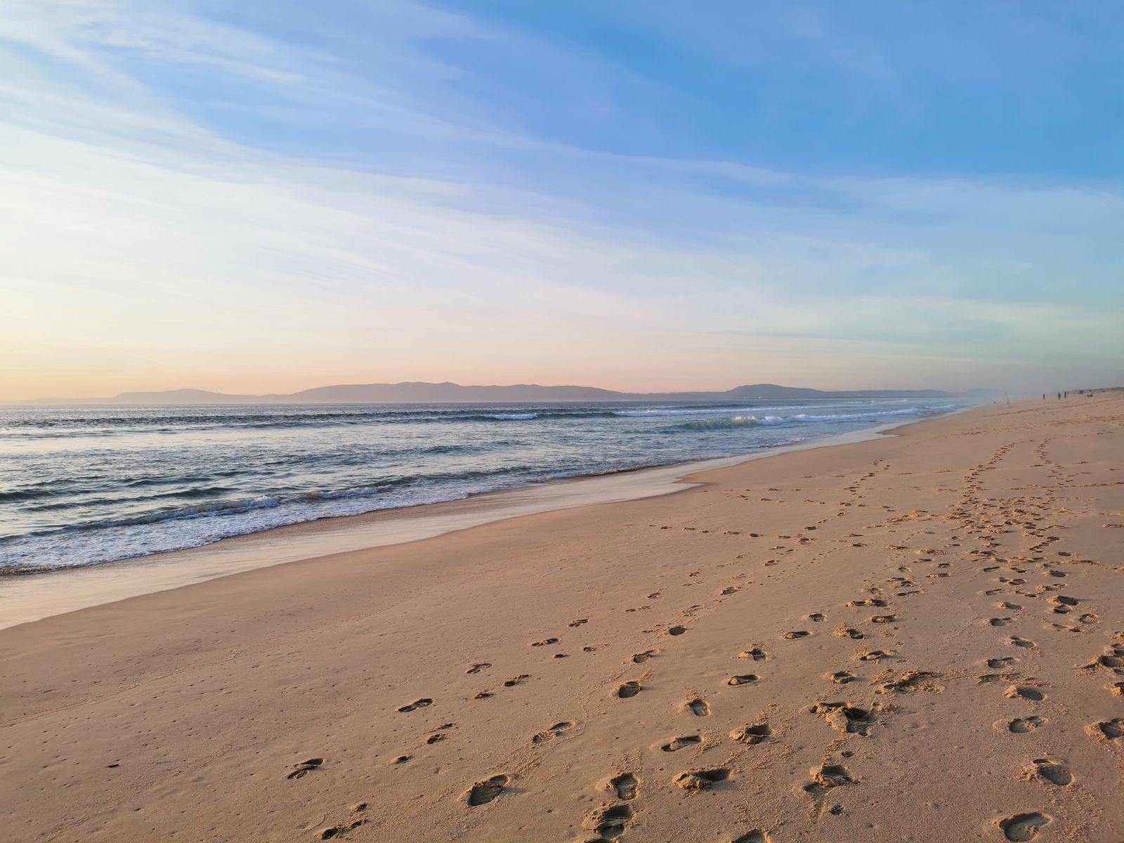 Footprints on a long empty beach at Comporta.