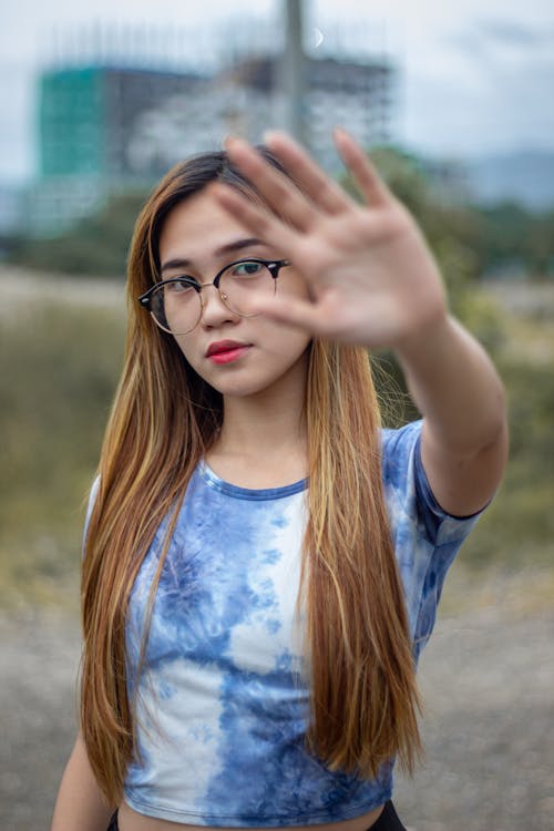 Free Photo of a Woman with Eyeglasses Covering Her Face with Her Hand Stock Photo