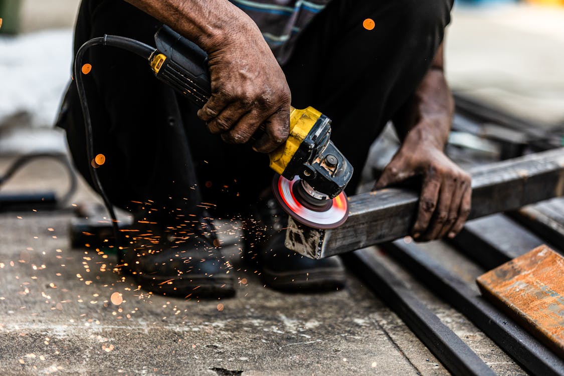 Man Holding a Grinding a Steel