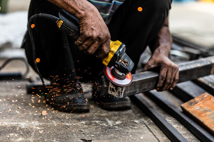 Man Holding A Grinding A Steel