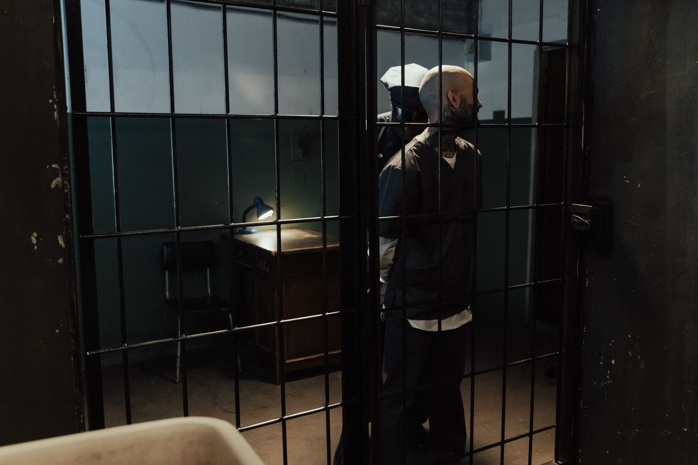 Correctional officer and incarcerated person near a cell
