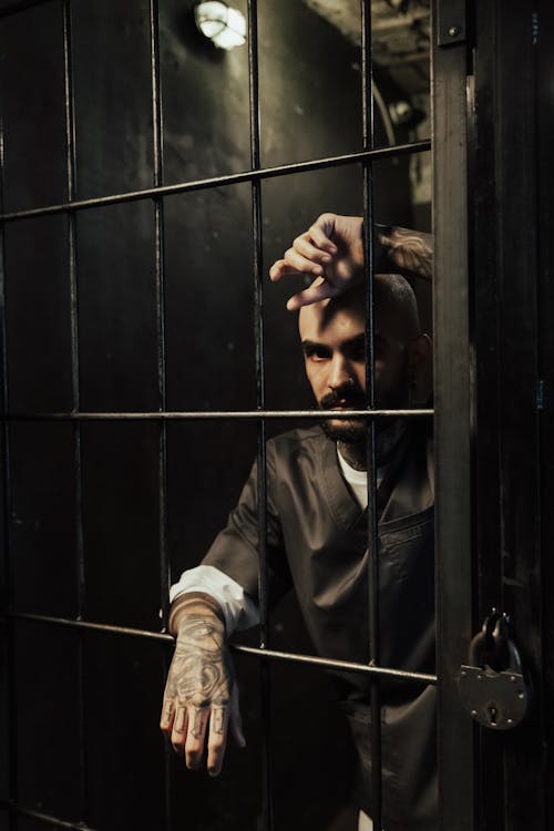Man with Tattoos in Prison Cell