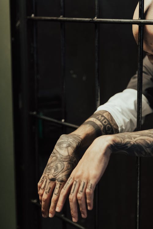 Free Prisoner Hands in tattoos Stock Photo