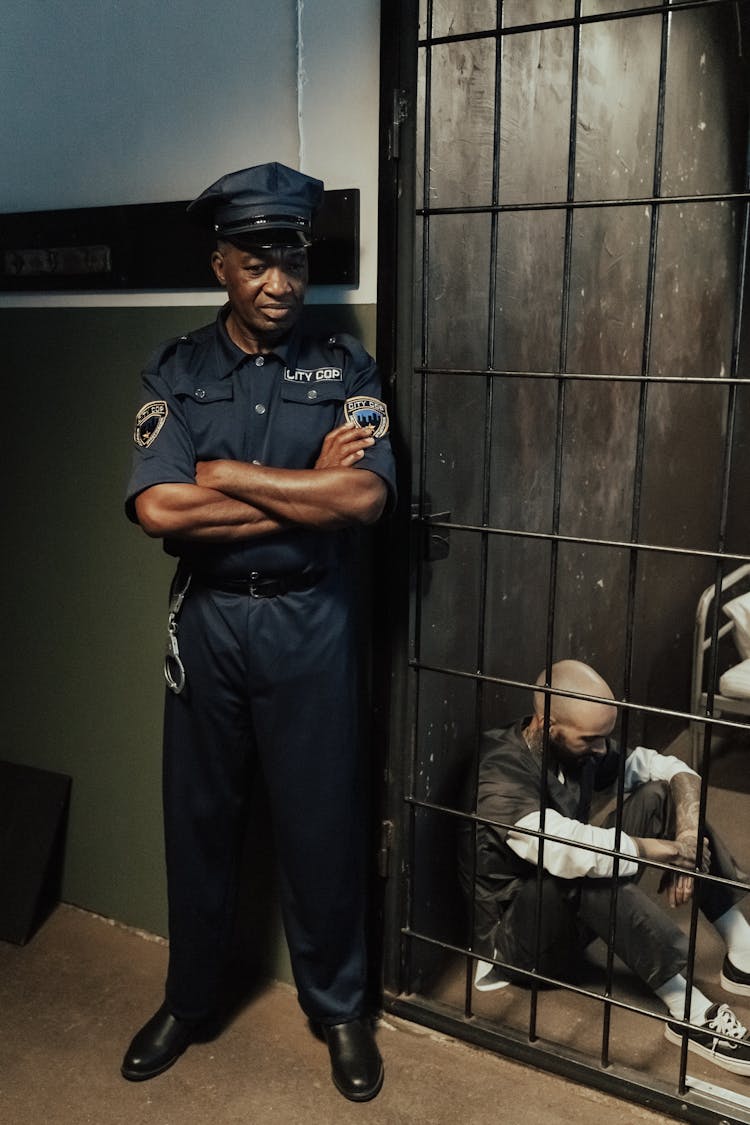 A Cop Monitoring The Man Inside The Cell